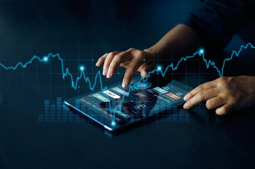 Businessperson using tablet to view stock charts.