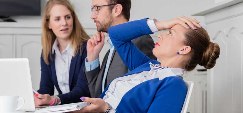 Businesswoman with her hand on her head.