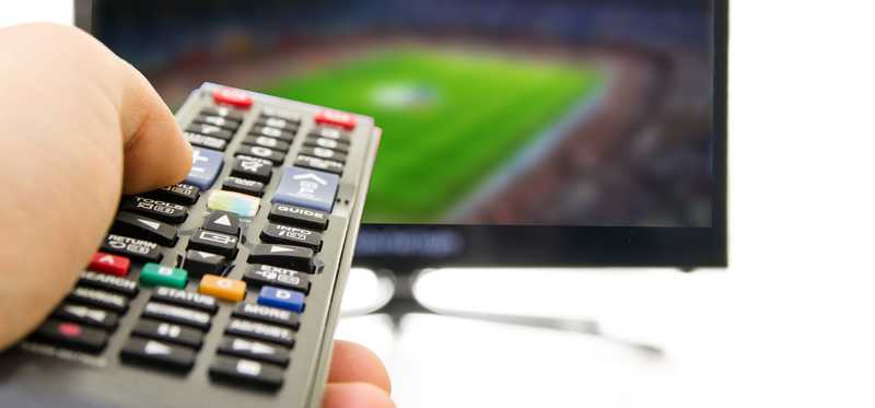 A cable television and remote pointed toward it