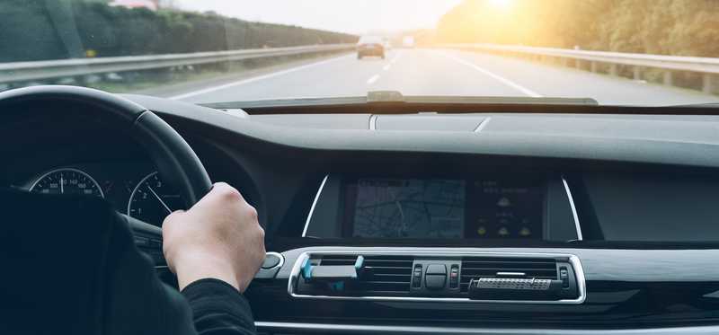 Dashboard view of a car on the road.