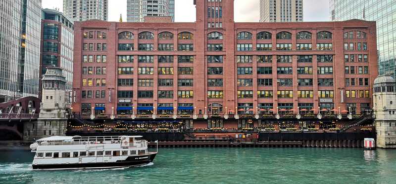 A ferry going down a river in Chicago