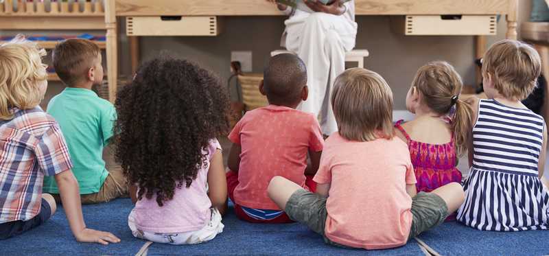 Rows of seated children in child care.