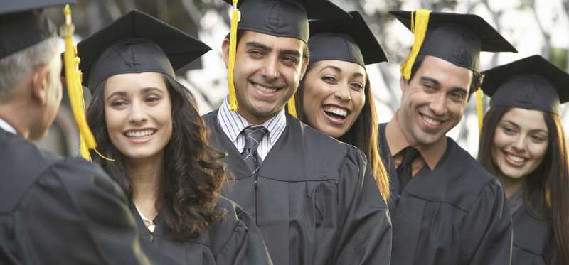 A row of college grads in caps and gowns.