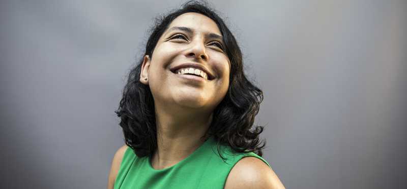 Person in green smiling.