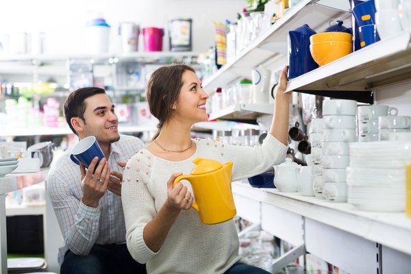 Consumers examining ceramics in a home furnishings store.