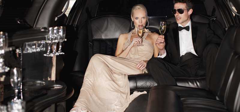 Couple drinking champagne in limo.