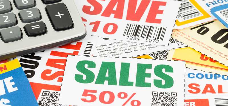 A messy pile of coupons with calculator on top.