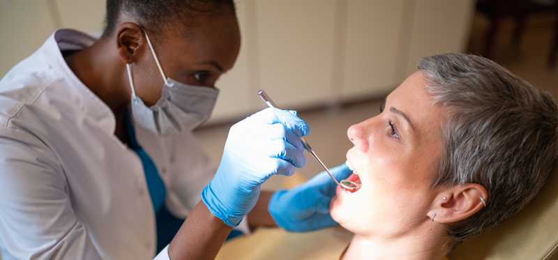Dentist checking patient's teeth.