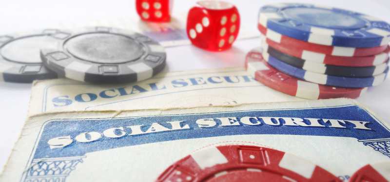 Dice and casino chips lying atop Social Security cards.