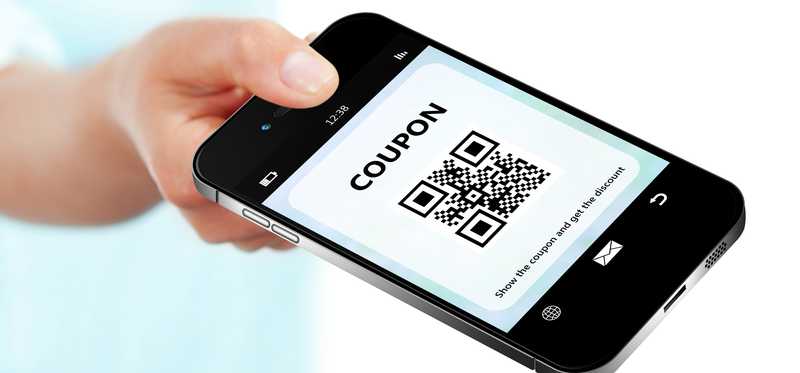 Hand holding a smartphone with a digital coupon on the screen.