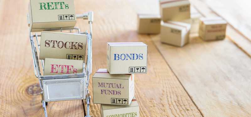 A shopping cart full of boxes with words representing different investments.