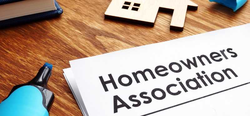 Documents that say Homeowners Association lying on a table.