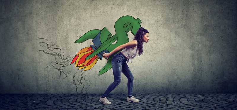 Woman holding a drawn dollar sign made into a rocket on her back as if to take off