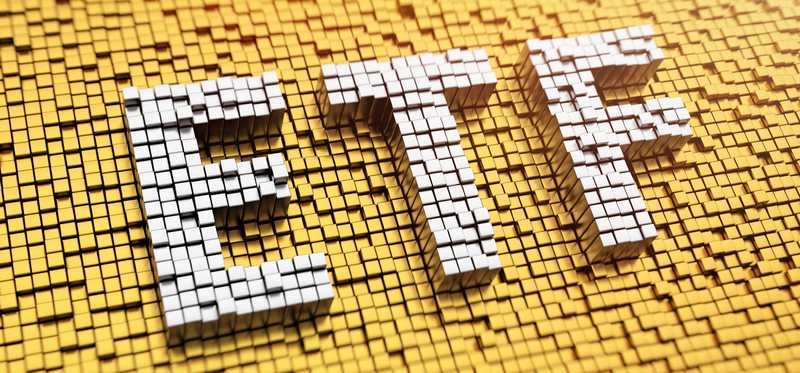 The word ETF in white blocks in a sea of yellow blocks.
