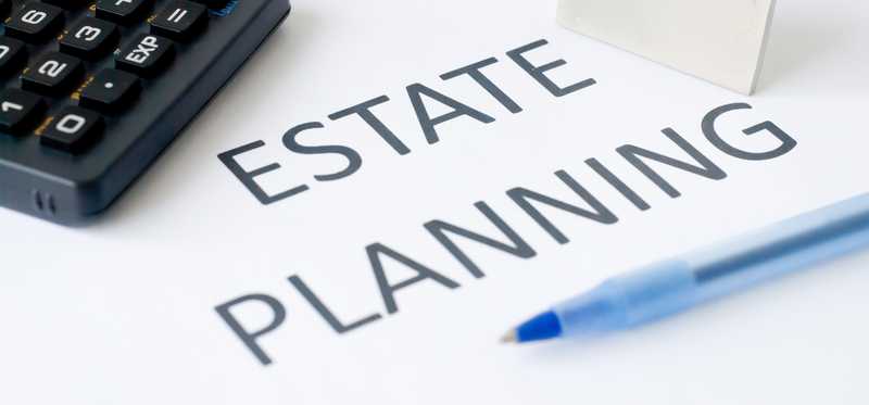 Estate planning document with calculator, pen, and house icon on top.