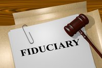 Fiduciary printed on paper with a gavel resting on top of it.