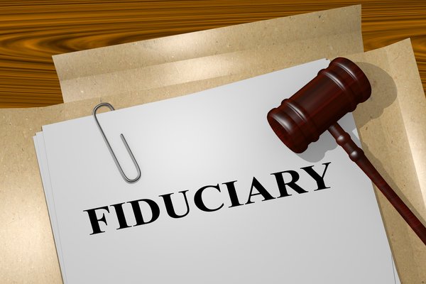 Fiduciary printed on paper with a gavel resting on top of it.