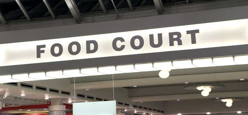 A sign in a mall says Food Court.