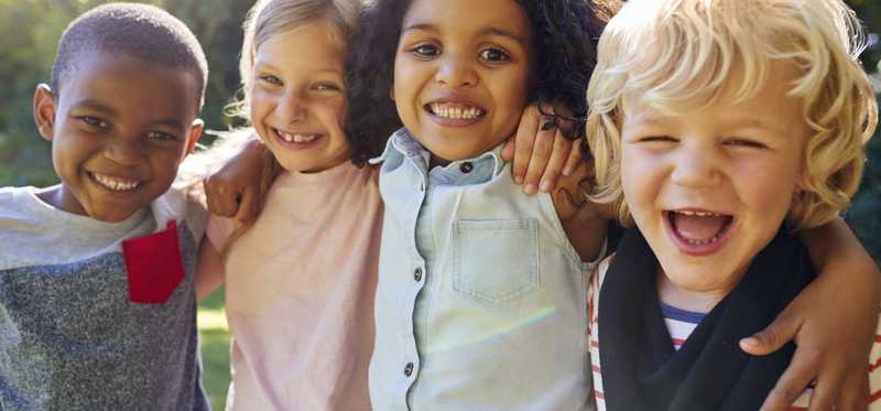 Four kids smiling.