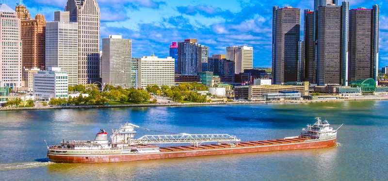 A freighter passes by downtown Detroit on the Detroit River.