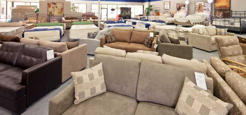 The inside of a furniture store with various couches and other items displayed.