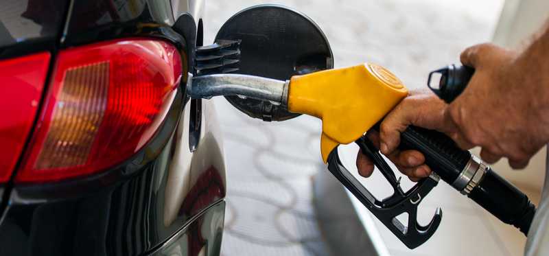 Gas being pumped into a vehicle.