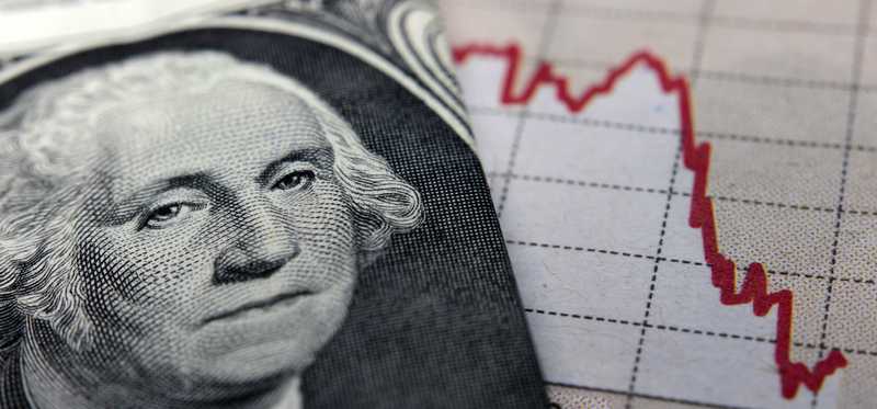 George Washington's face prominently featured on a one dollar bill that's next to a falling chart.