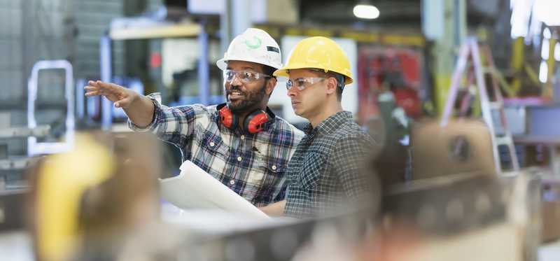Two people working in manufacturing facility.