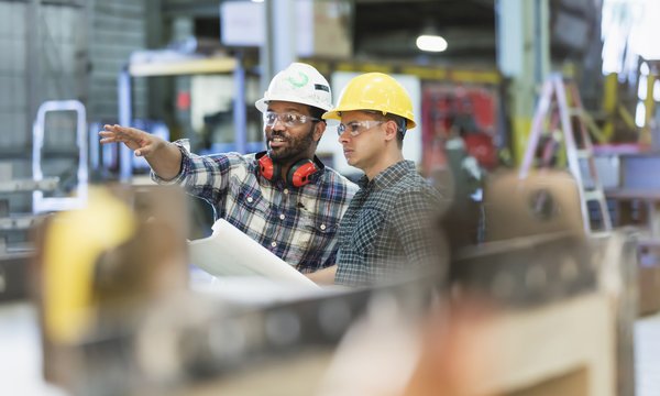 Two people working in manufacturing facility.