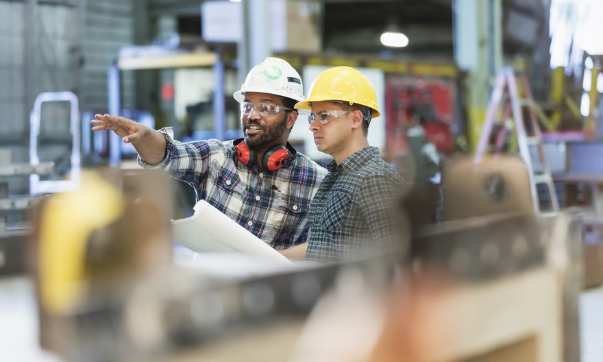 Two people working in manufacturing facility.