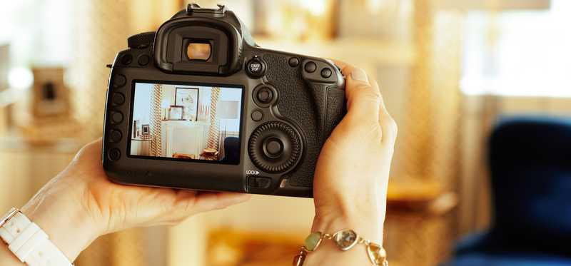 Professional photographer taking picture of home.