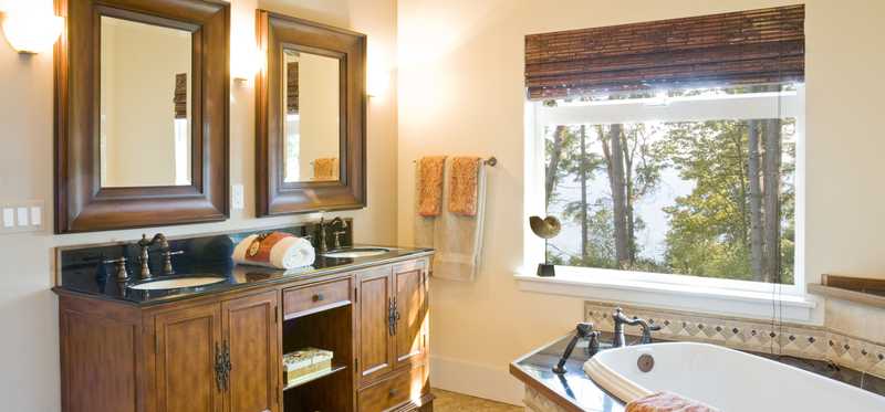 Bathroom with double sink and vanity and big washtub.
