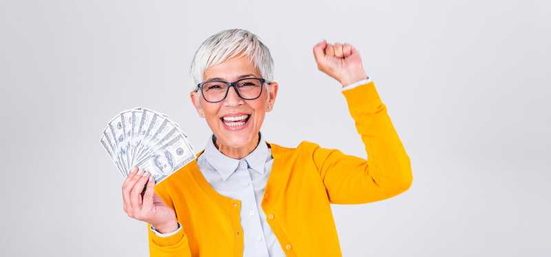 Person holding money and cheering.