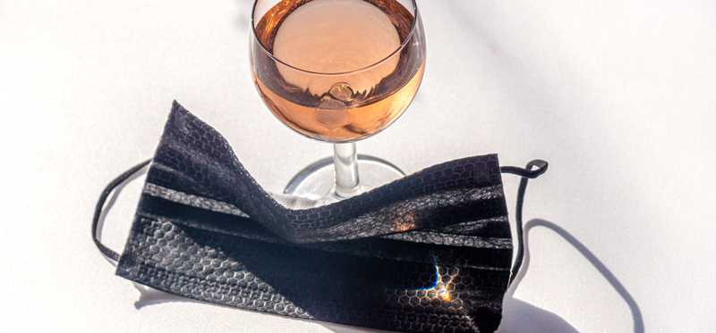 Glass of champagne and face mask.