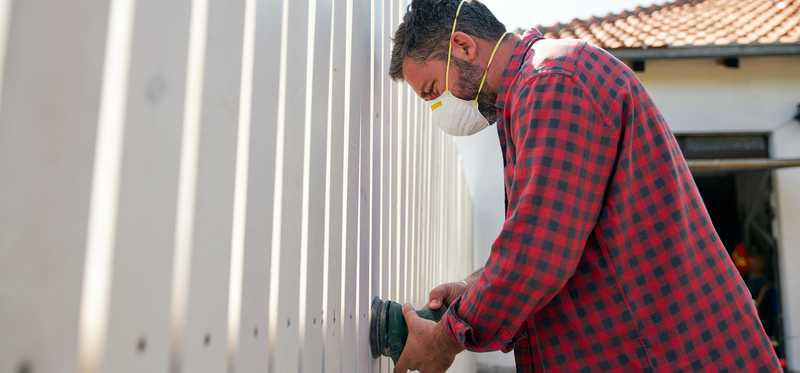 Person putting up fence.