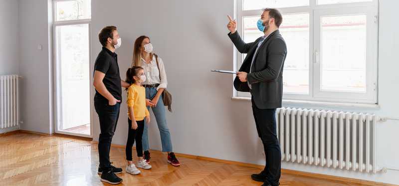 Property manager showing a rental property to a family.