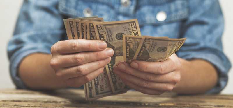 Person holding money.