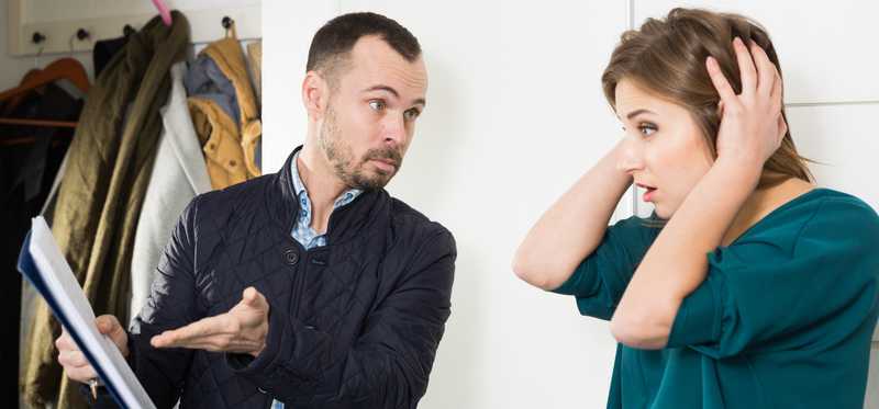 Person showing a contract to another person who looks shocked.
