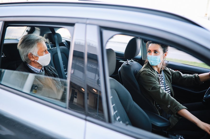 Female driving a rideshare car in the times of coronavirus pandemic.