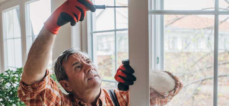 Person fixing a window.