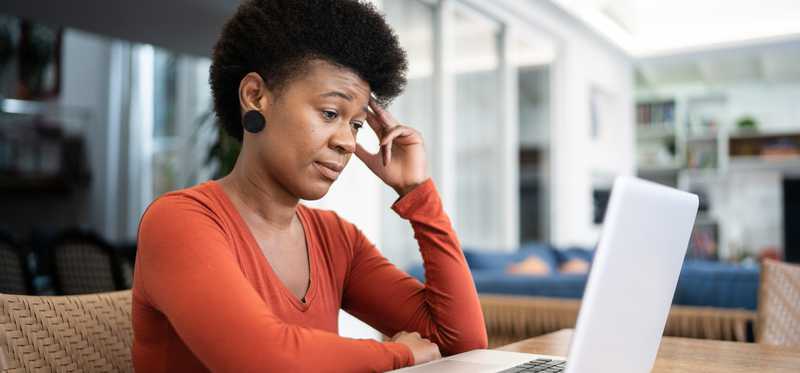 Uninterested or skeptical person looking at computer.