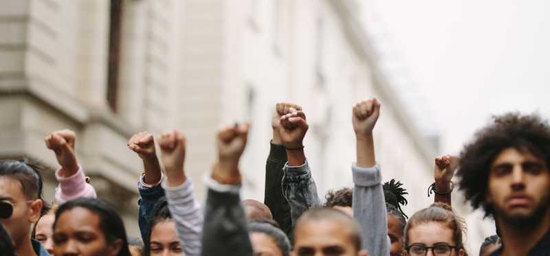 People raising fists at a protest.