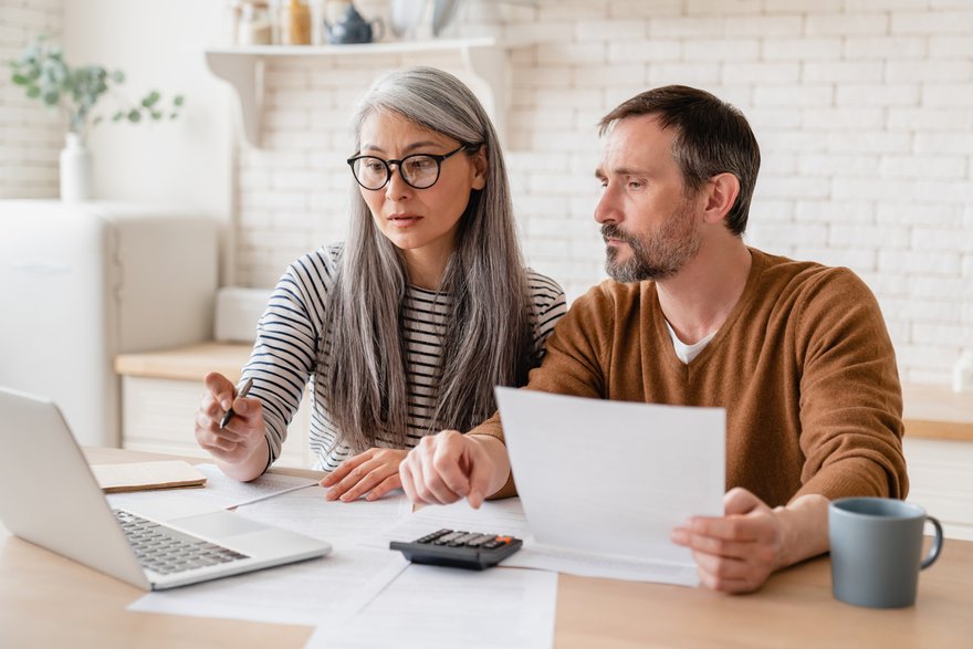 Couple at table looking at laptop