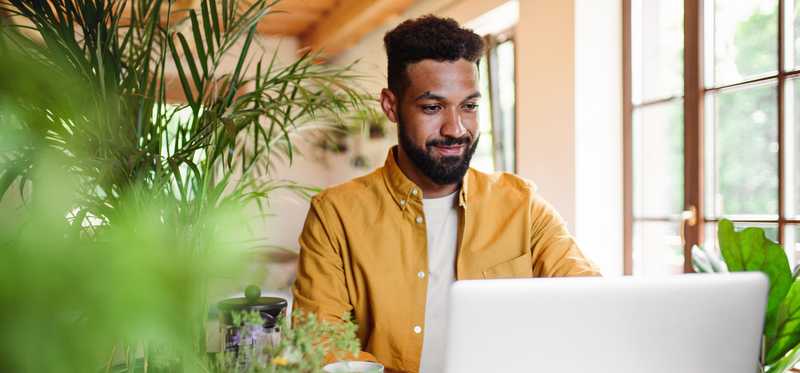 A person with a laptop and coffee.