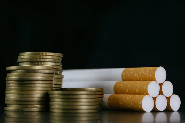 Cigarettes and coins lying on a table.