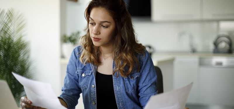 Person sitting at a desk and working on taxes.