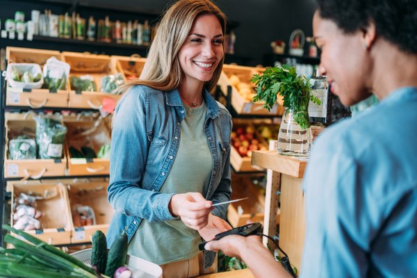 A person paying at a store with a debit card.