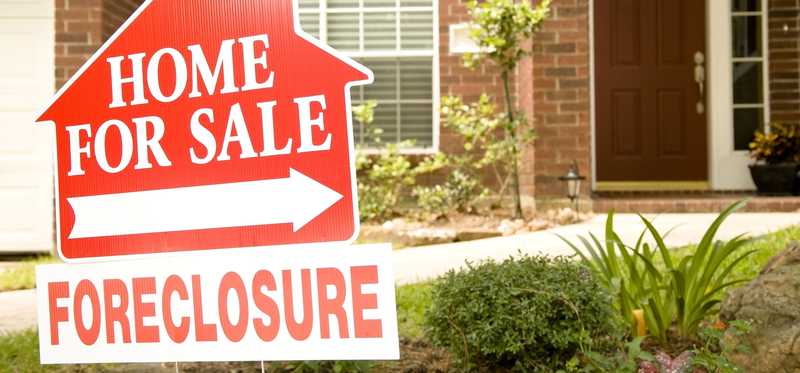 Foreclosure sign in front of house.