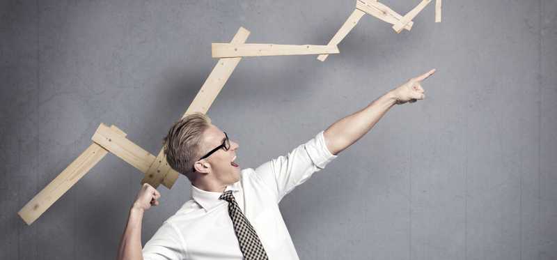 Person pointing excitedly to an arrow going up.