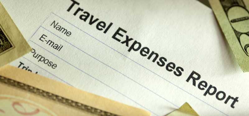 A Travel Expenses Report with money lying on it.